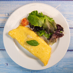 Omelette with salmon and herbs, served on plate, traditional Norwegian dish