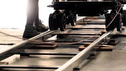 Dolly track for film industry. Behind the scenes of video production team setting dolly track for...