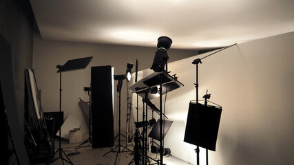 Studio lighting setup for photo shooting or video recording production with many equipment such as...