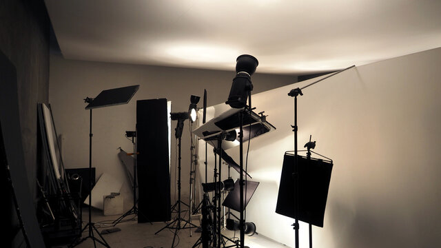 Studio lighting setup for photo shooting or video recording production with many equipment such as softbox, backdrop paper, white reflect foam and many more. Professional tools for film industry.