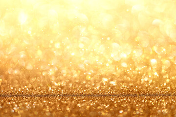 Blurred defocused bokeh background with Christmas lights and golden glitter sparkles
