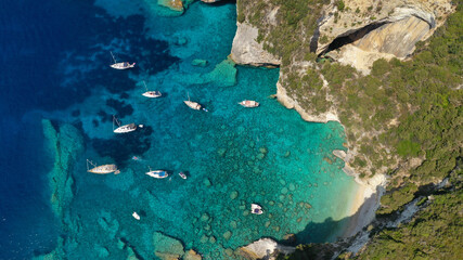Aerial photo of luxury sail boat anchored in tropical Caribbean rocky turquoise colour seascape