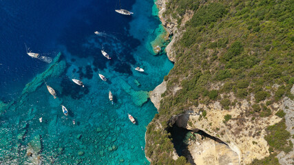 Aerial photo of luxury sail boat anchored in tropical Caribbean rocky turquoise colour seascape