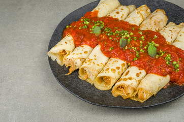 Brazilian pancakes with chicken, tomato bolognese sauce, rolled pancakes.