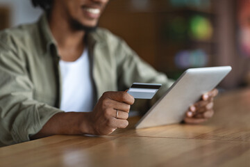 Online Payments. Closeup Of Black Man Using Digital Tablet And Credit Card
