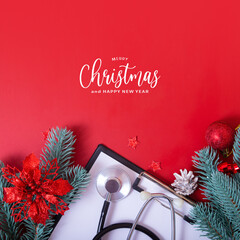 Merry Christmas text with medical stethoscope and christmas decorations on red background