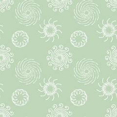 Seamless background of white mandalas in the shape of flowers on a green background. Hand-drawn retro ornament. Design of background, template, wrapping paper, wallpaper, fabric, textile, cover.