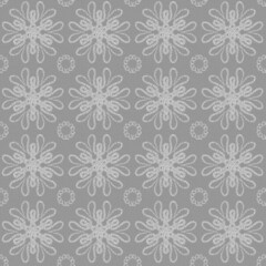 Seamless geometric pattern of mandalas, lace, sinuous lines. A white ornament on a grey background,hand drawn. Retro style. Design of the background, interior, wallpaper, textiles, fabric, packaging.