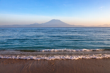 Mount Agung active volcano in Nusa Penida, Bali island, Indonesia. Amazing sunset. Sand beach. High...