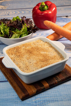 Salmon Parmentier recipe with hazelnuts, young salad leaves. High quality photo