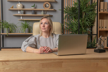 Woman sits on a chair girl office, technology beautiful people attractive studio, relaxation. Pose cute, furniture joyful