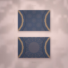 Presentable business card in blue with a greek brown pattern for your brand.