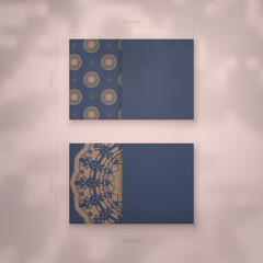 Presentable business card in blue with abstract brown ornament for your brand.