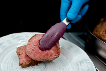 On a plate put two pieces of fried medium roasting purple tongs