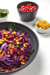 Homemade Purple Cabbage Salad with Corn, Carrots, Pomegranate and Spinach
