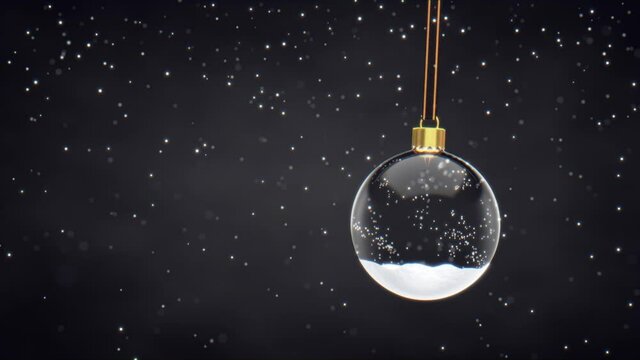 Snow falling over snow glass bauble on black background with copy space. Christmas decoration background animation