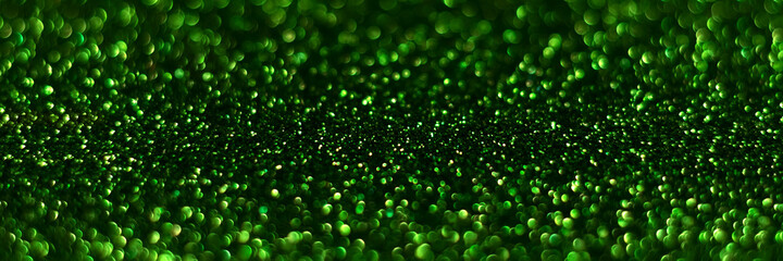 Green sparkling glitter bokeh background, christmas texture. Holiday lights. Abstract defocused...