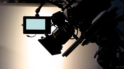 Video recording. Behind the scenes or the making of film video production and movie crew team working in silhouette of camera and equipment set in studio. Professional video production. film industry.