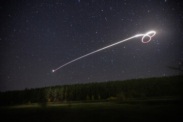 flying a quadcopter at night in the starry sky