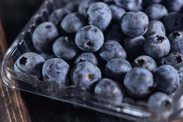 Close-up of box with blueberries on a wooden table