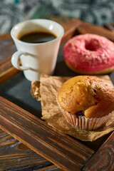 Morning coffee with sweet muffin pn a kitchen black board