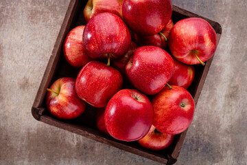 Ripe red apples in wooden box. Top view with space for your text.