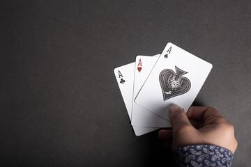 Four aces playing cards in man hand - Powered by Adobe