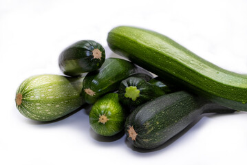 Green zucchini, ripe vegetable on a white background.