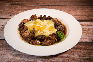 Recipe of sweetbread and lamb kidney with cocoa, leek whistles with almonds and oranges. High quality photo