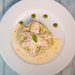 Baked sole fillet, risotto and pesto recipe. High quality photo