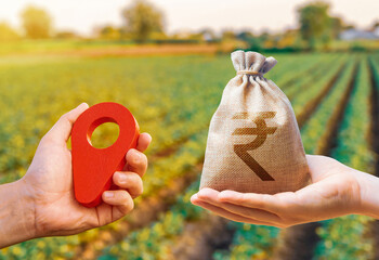 Hands with location pin and indian rupee money bag. Land market. Estimation cost of plots. Agriculture agribusiness. Transport and construction industry. Buying and selling land.