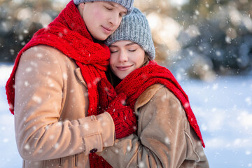 Closeup portrait of loving couple enjoying snowy winter day together