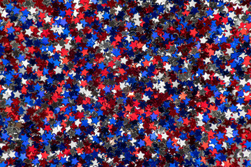 Background of small red, white and blue shiny stars, colors of the flag of united states of america perfect for textures and graphic design backgrounds