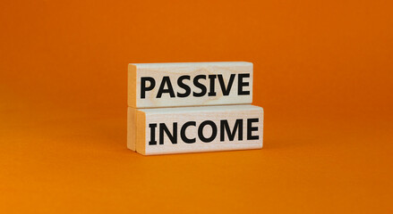 Time to passive income symbol. Concept words Passive income on wooden blocks on a beautiful orange background. Business and passive income concept. Copy space.