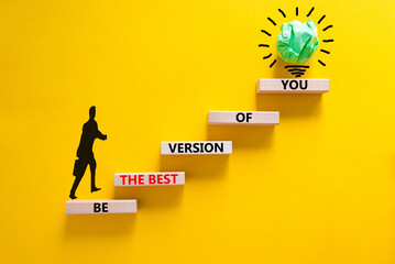 Best version of you symbol. Wooden blocks with words Be the best version of you on yellow background, copy space. Businessman icon, light bulb. Business, best version of you concept.