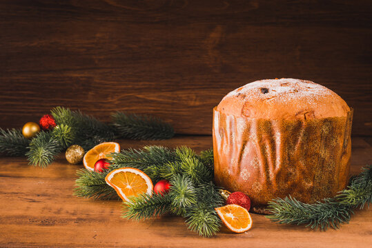 Panettone traditional Italian Christmas cake on wooden background copy space.