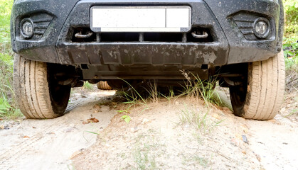ground clearance of an SUV on a sandy road - obrazy, fototapety, plakaty