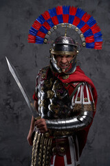 Violent legionnaire wielding gladius screaming against dark background