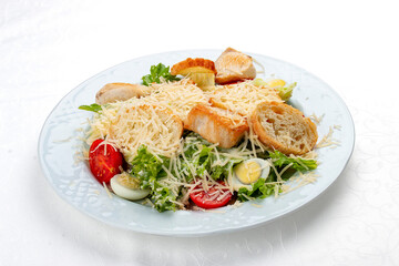 Fototapeta na wymiar Caesar salad with chicken, egg and fresh vegetables. Isolated on a white background