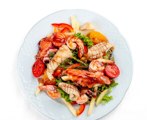 Salad Di Mare. Salad with shrimp, salmon and squid, orange and sweet pepper. Isolated on a white background