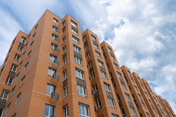 Apartments Building Towers. New building. The facade of the new residential high-rise buildings against the sky. The concept of building a typical residential neighborhood.
