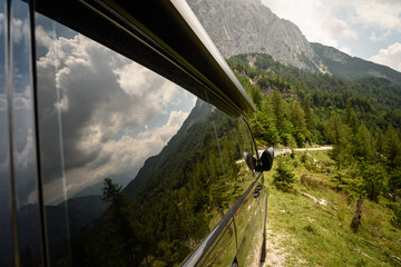 View of Julian Alps mountains near Kranjska Gora in Triglav national park reflected on a camper van...