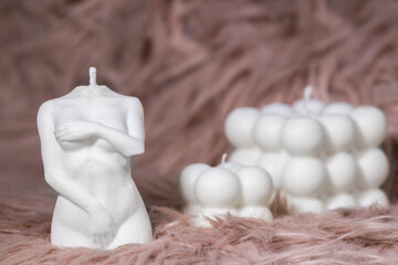Trendy Woman Body Soy Wax and Cube Bubble Candle on pink soft background, Interior object