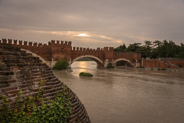 Castelvecchio bridge made of brick and marble over Adige river at sunset. Built in the s. XIV and...