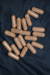 Transparent capsules filled with brown vitamins powder close up background high quality big size prints