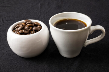 Coffee beans in cups on a black background