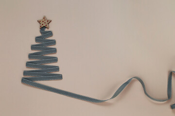 Christmas tree made from ribbon with a star. Place for your text.
