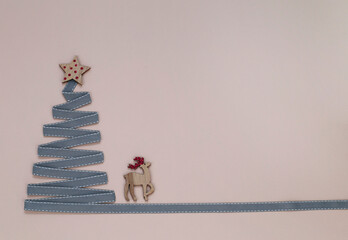 Christmas tree made from ribbon with a star. Place for your text.
