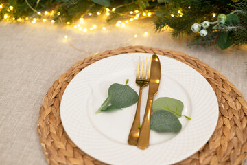 Christmas kitchen decor and table settings. Rustic cuisine at Christmas. Details of scandinavian cuisine in gold color. Kitchen island festive 
 table
