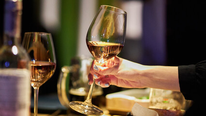 Glasses in the hands of a company of people. The girl has a glass in her hands. 